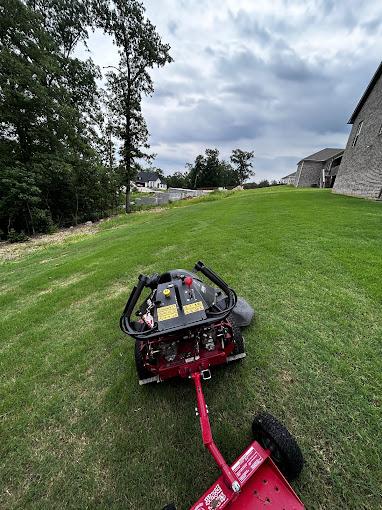 Elite Grounds riding mower on a residential lawn in Little Rock